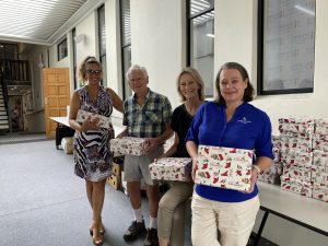 Volunteers receiving donation of gifts from St James Anglican Church